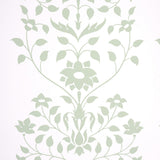 Jaipur Mughal Flower wallpaper in green by Schumacher, featuring a stylized floral pattern inspired by Mughal motifs, shown in a modern interior setting.