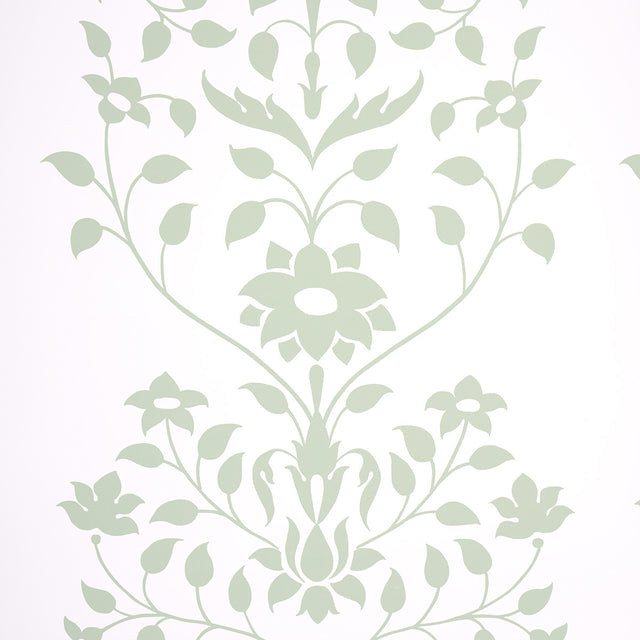 Jaipur Mughal Flower wallpaper in green by Schumacher, featuring a stylized floral pattern inspired by Mughal motifs, shown in a modern interior setting.