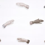 Manos wallpaper in neutral by Charlap Hyman & Herrero for Schumacher, featuring surrealist hand motifs on a white background.