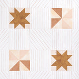 Alexander wallpaper in terracotta and warm peach, featuring geometric quilt-inspired star and pinwheel motifs on a multidirectional striped background.
