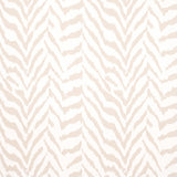 Quincy Natural wallpaper by Schumacher featuring a subtle animal-inspired pattern in neutral tones, styled in a classic interior setting.