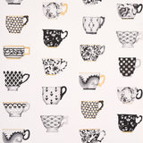 Onie's Teacups wallpaper in Ink by Schumacher, featuring hand-painted porcelain teacups with chinoiserie motifs in black, white, and gold.