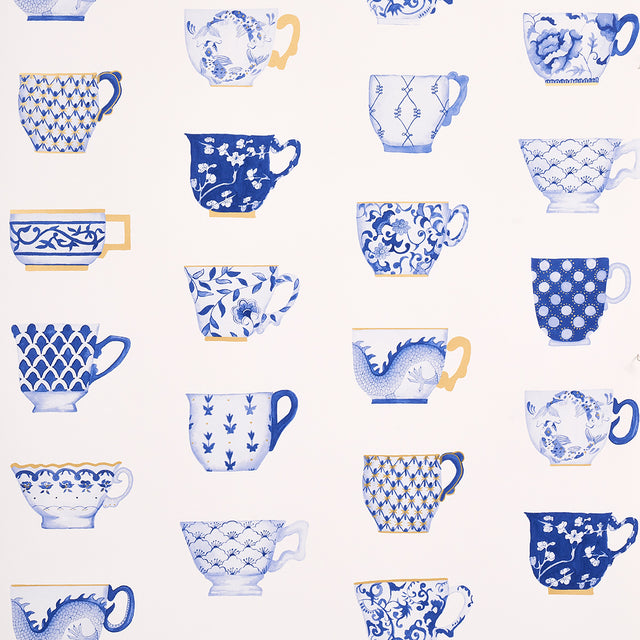 Onie's Teacups wallpaper in porcelain by Schumacher, featuring hand-painted blue and white teacups with gold accents on a light background.