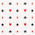 Le Joueur wallpaper in rouge-et-noir by Schumacher, featuring playful card suit motifs in red and black on a white background.