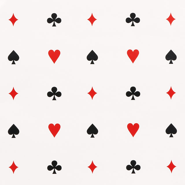 Le Joueur wallpaper in rouge-et-noir by Schumacher, featuring playful card suit motifs in red and black on a white background.