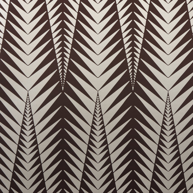 Zebra wallpaper in brown and silver by Neisha Crosland for Schumacher, featuring a bold abstract animal-inspired geometric pattern.