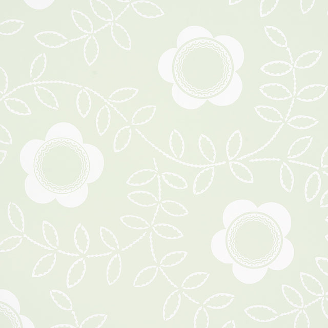 TUDOR ROSE wallpaper in Pistachio by Schumacher, featuring a large-scale floral pattern in white on a soft green background, styled in a bedroom setting.