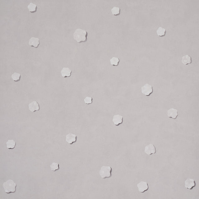 Heavenly Bodies wallpaper in gray by Schumacher, featuring abstract star and cloud motifs on a soft background.