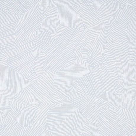Labyrinth Grand wallpaper in Sky by Schumacher, large-scale geometric pattern in light blue and white, shown in a styled bedroom interior.