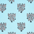 Bow-Wow-Wow wallpaper in Aqua by Schumacher, featuring bold black and white bow motifs on a light blue background.