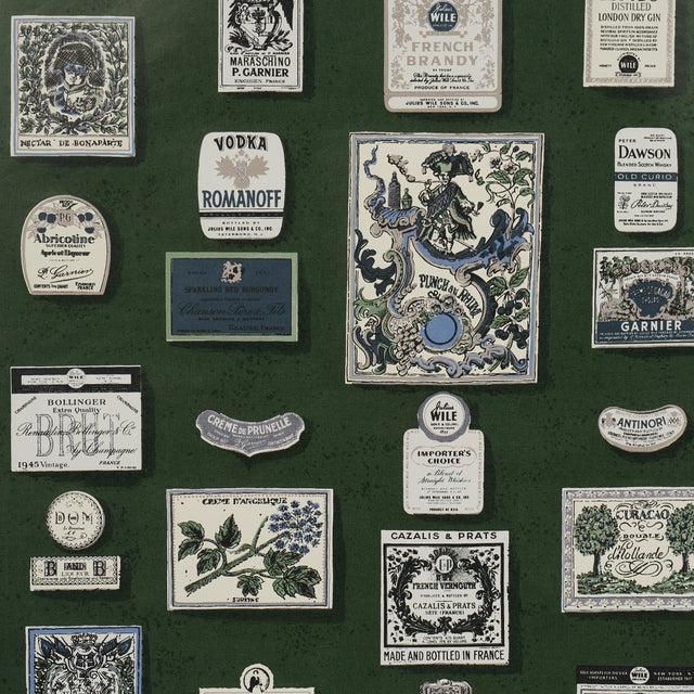 SALUD by Backdrop for Schumacher in Rosemary. Retro liquor bottle label wallpaper in green with vintage-inspired illustrations.