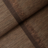 Axel Fringe Wallcovering in brown and copper, a large-scale vertical stripe wallpaper with fringe detail by Schumacher, shown in a styled bedroom.