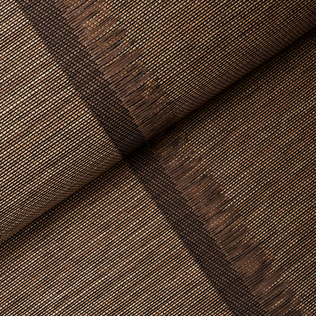 Axel Fringe Wallcovering in brown and copper, a large-scale vertical stripe wallpaper with fringe detail by Schumacher, shown in a styled bedroom.