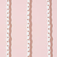 Rousseau Stripe wallpaper in cocoa and blush by Schumacher, featuring wavy vertical stripes with polka dots on a soft pink background.