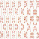 Quiver Sunset by A Rum Fellow for Schumacher. Modern chevron stripe wallpaper in sunset hues, shown in a styled bathroom and as a roll.