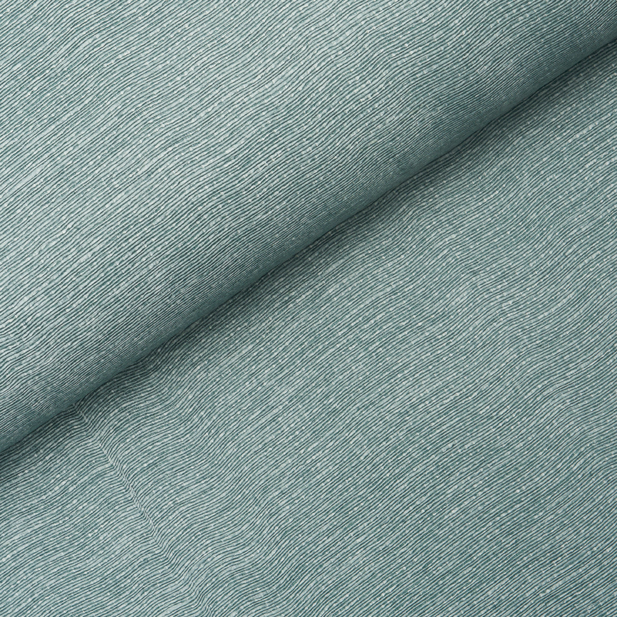 Linen Plissé Wallcovering in Adriatic Blue by Schumacher, shown in detail and installed in a bedroom setting.