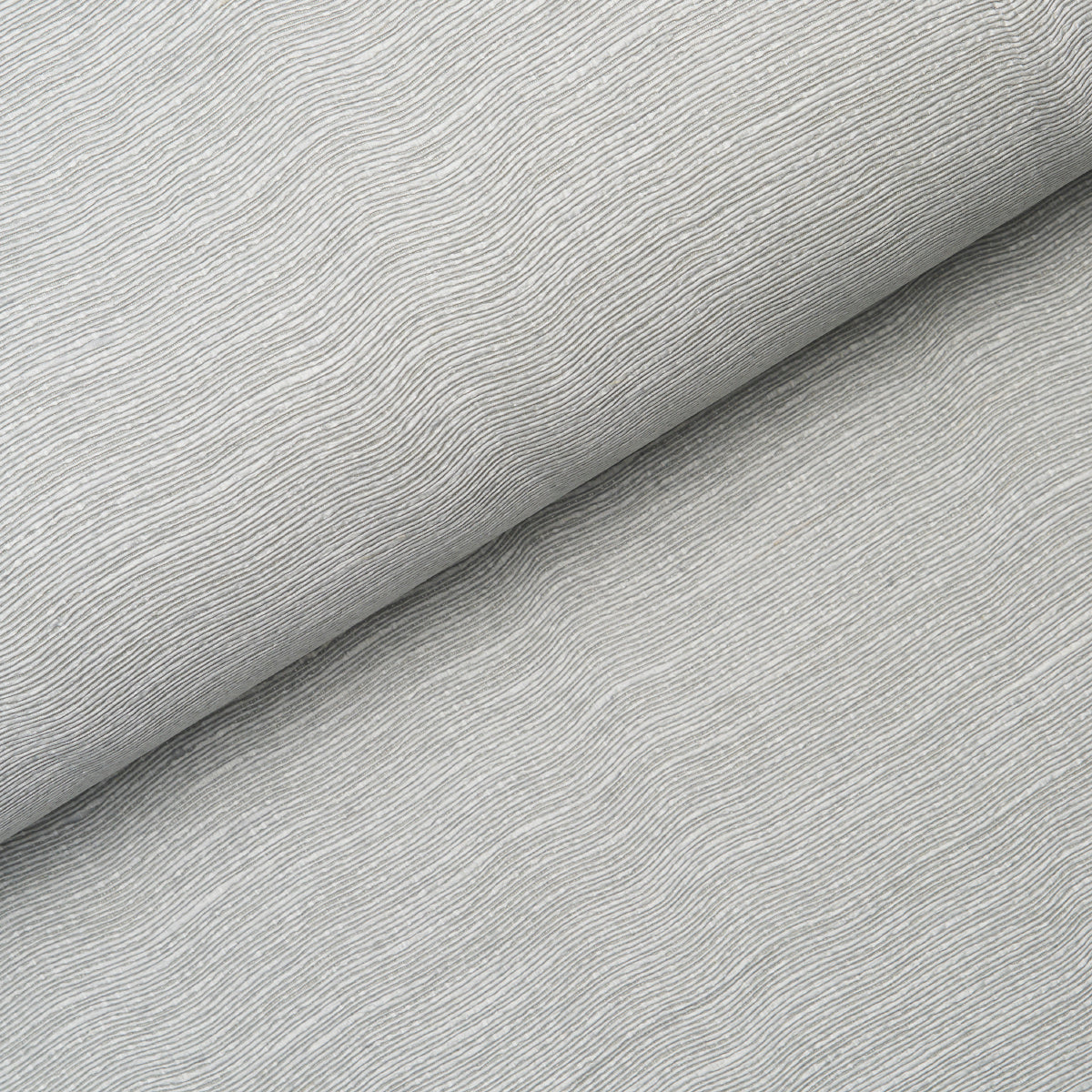 Linen Plissé Wallcovering in Mist by Schumacher, showing a close-up of the puckered linen texture and a styled room view.