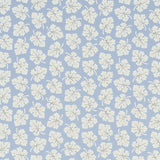 Olive Sky by Rita Konig for Schumacher - small-scale multidirectional leaf motif wallpaper in blue and white, shown in a styled bathroom interior.