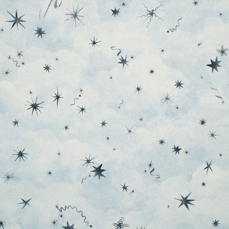 Luminaries wallpaper by Backdrop x Xavier Donnelly for Schumacher, featuring whimsical stars and celestial objects on a soft blue cloudscape background.