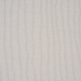 La Voie Wallcovering in Fog by Schumacher, a woven jacquard wallpaper with organic striping, shown in a modern bedroom setting.