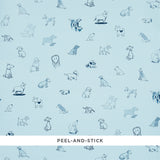 Good Dogs Everywhere peel-and-stick wallpaper in sky and navy blue featuring charming dog illustrations from The New Yorker collection by Schumacher.