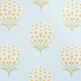 Aurelia Sky wallpaper by Schumacher featuring large stylized yellow and white blossoms on a soft blue background, shown in a bathroom setting.