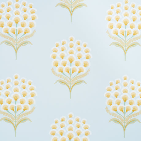 Aurelia Sky wallpaper by Schumacher featuring large stylized yellow and white blossoms on a soft blue background, shown in a bathroom setting.