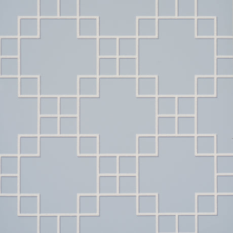 Georgette Trellis wallpaper in light blue with a geometric lattice pattern by Schumacher, shown in a styled bathroom interior.