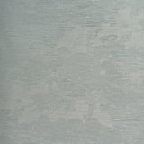 Drifting Cloudscape Mist wallpaper by Schumacher, a large-scale woven wallcovering with a subtle cloud-inspired pattern and metallic shimmer, shown in a serene bedroom setting.