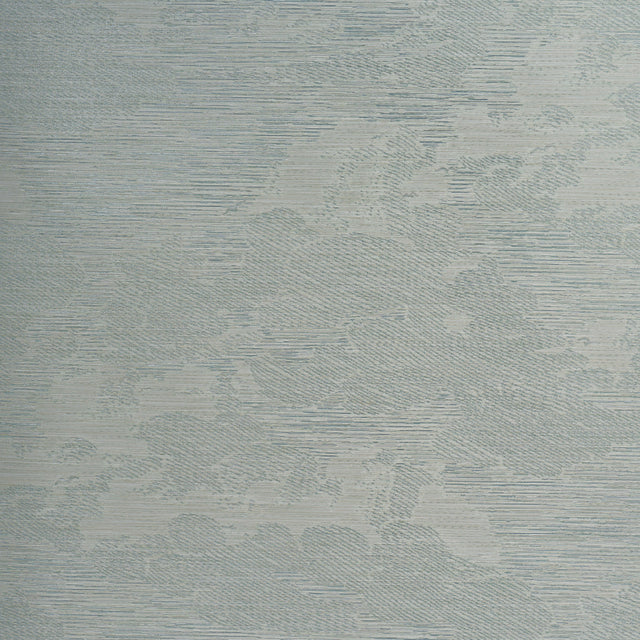 Drifting Cloudscape Mist wallpaper by Schumacher, a large-scale woven wallcovering with a subtle cloud-inspired pattern and metallic shimmer, shown in a serene bedroom setting.