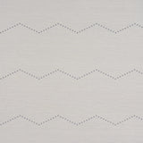 Rivet Stripe Sisal wallpaper in Dove by Schumacher, featuring a horizontal chevron stripe pattern formed by delicate dots on a textured sisal background.
