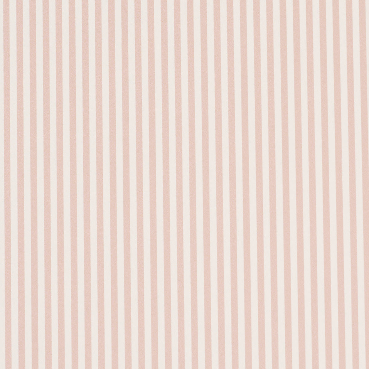 Emma Stripe Narrow wallpaper in blush by Schumacher, featuring narrow vertical stripes in a soft pink hue, shown in a styled bathroom setting.