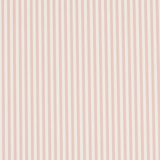 Emma Stripe Narrow wallpaper in blush by Schumacher, featuring narrow vertical stripes in a soft pink hue, shown in a styled bathroom setting.
