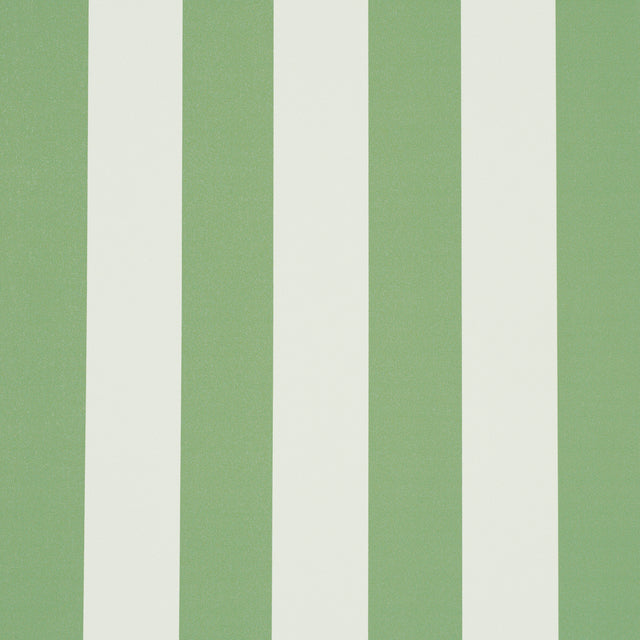 Emma Stripe wallpaper in Apple Green by Schumacher, featuring bold vertical green and white stripes, shown in a styled bathroom interior.