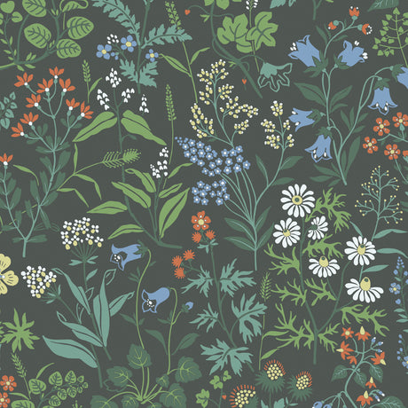 Flora Spruce wallpaper by Boråstapeter for Schumacher, featuring a lively allover wildflower pattern in green, blue, white, and orange on a dark background.