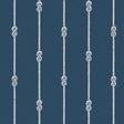 Navy blue wallpaper with vertical white nautical rope stripes and figure-eight knots, styled in a coastal interior setting.