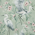 Fine Decor Simonetta Seafoam Heron Wallpaper roll showing white herons and pink blossoms on a green background.