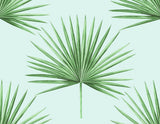 Pacific Palm peel and stick wallpaper in celeste and jade with green palm fronds on a light aqua background.