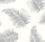 Tossed Palm peel and stick wallpaper in Alloy grey with scattered palm fronds.