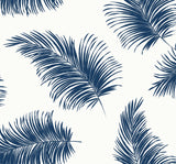 White peel and stick wallpaper with tossed navy palm fronds