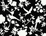 Kauai Bird Toile wallpaper in Inkwell featuring white bird and floral toile silhouettes on a black ground