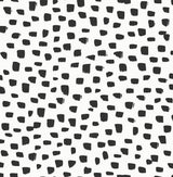 Black speckled dot pattern on a white background peel and stick wallpaper