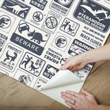 Jurassic World: Dominion Signs Blue Peel & Stick Wallpaper with Dinosaur Warning Sign Motif - York RMK12462RL