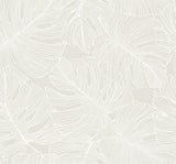 Tarra Monstera Leaf wallpaper in White Sand with overlapping tropical monstera leaves in a matte finish.