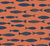 Coastal fish pattern wallpaper in coral orange with navy fish silhouettes.